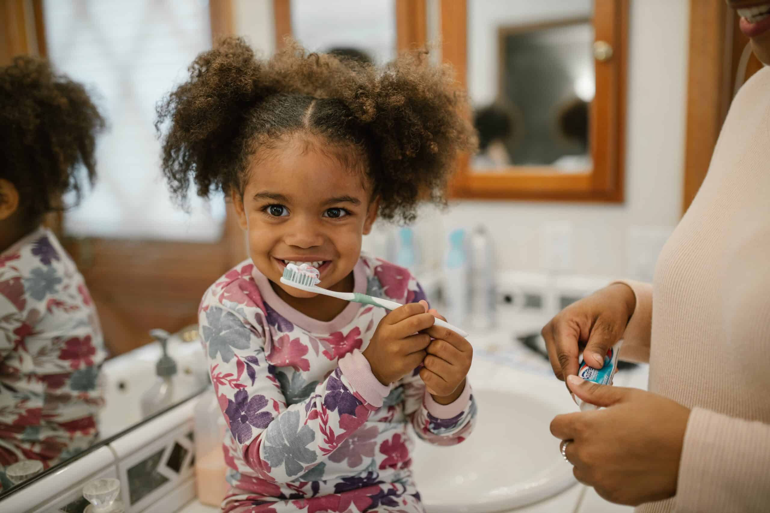 little girl brushing her teeth after visiting our Lorton, VA pediatric dentist